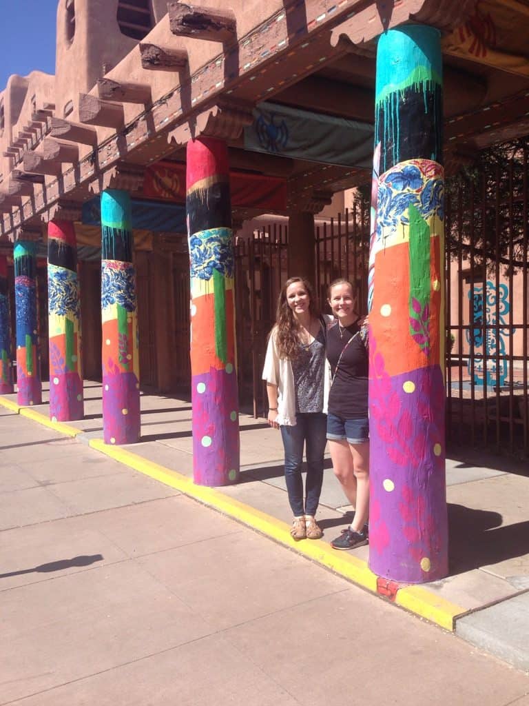 two women near colorful columns at a museum